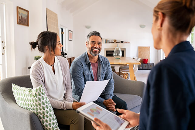 Woman Talking About Business With Couple In The Living Room